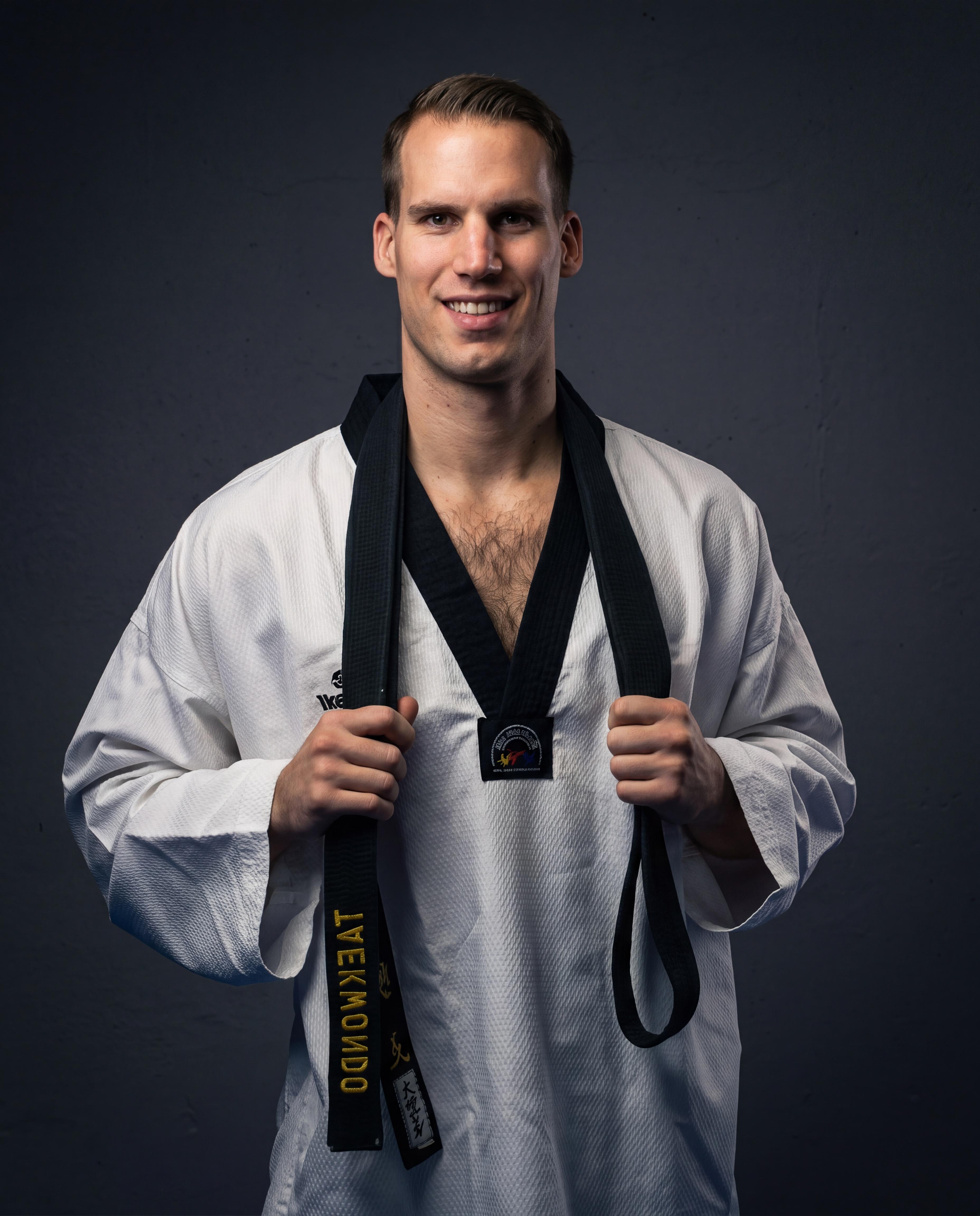 Portrait of head coach Vedran Golec in his dobok with a black belt around his neck